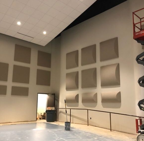 A photo of barrel sound diffusers installed in a large room.Diffusers are ideal for critical listening environments such as band rooms, churches and music recording studios.