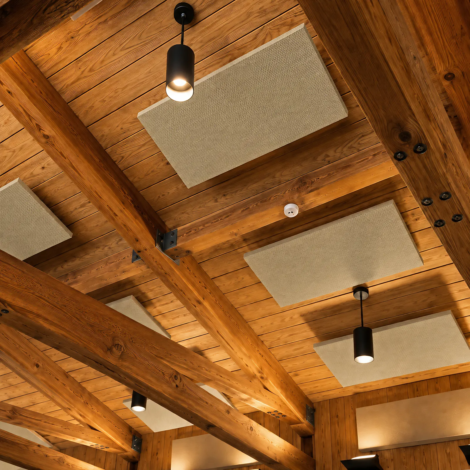 Acoustic ceiling cloud panels in Hush beige hung from a timber beam and wood plank ceiling